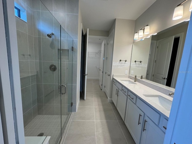 bathroom featuring tile patterned floors, vanity, and a shower with shower door