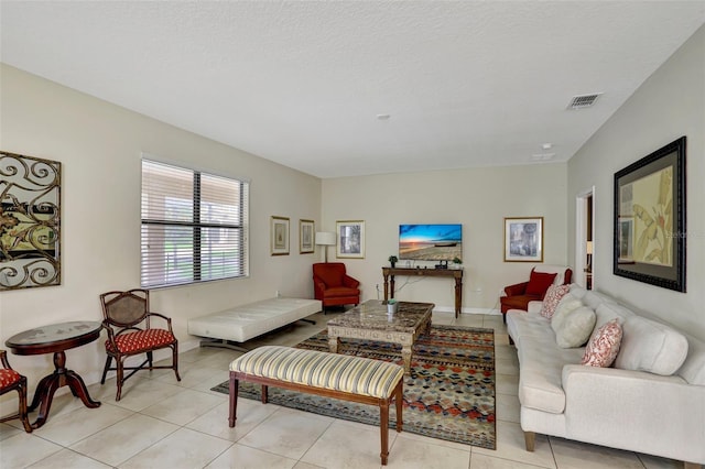 living room featuring light tile patterned floors and a textured ceiling