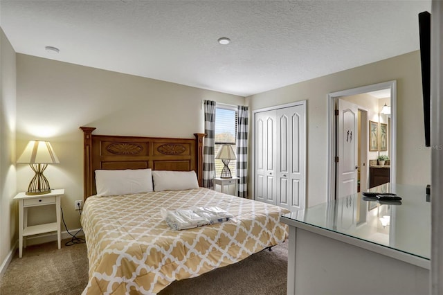 carpeted bedroom featuring a textured ceiling and a closet