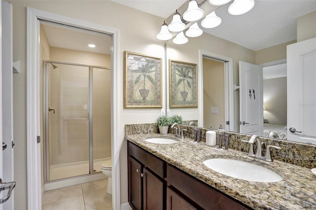 bathroom featuring tile patterned flooring, vanity, an enclosed shower, and toilet