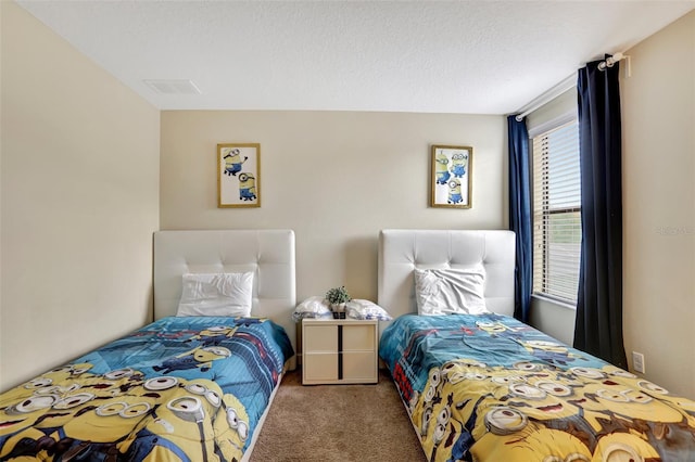 carpeted bedroom featuring a textured ceiling