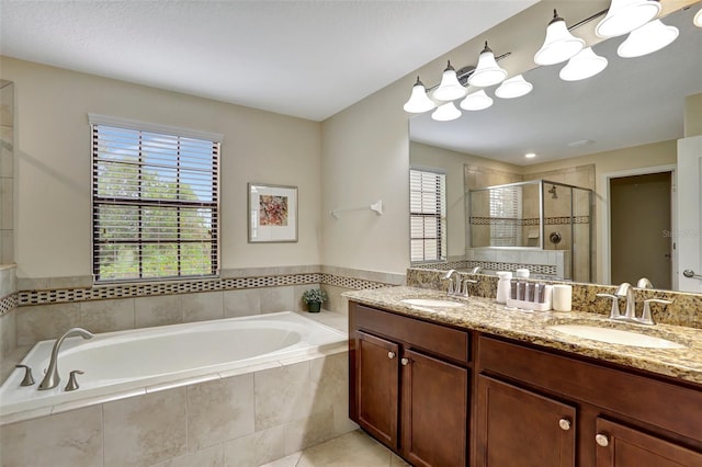 bathroom featuring tile patterned floors, plenty of natural light, vanity, and plus walk in shower