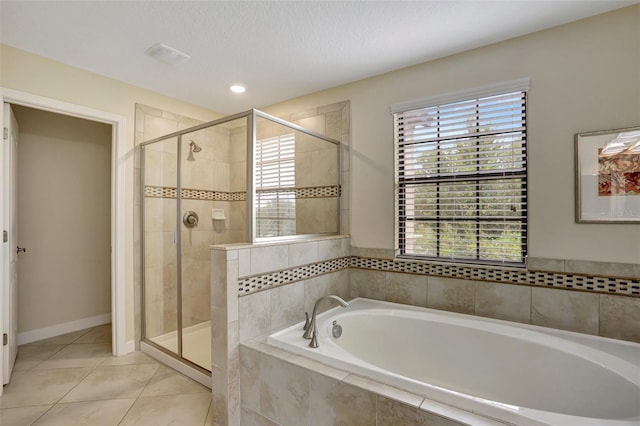 bathroom with tile patterned flooring and independent shower and bath