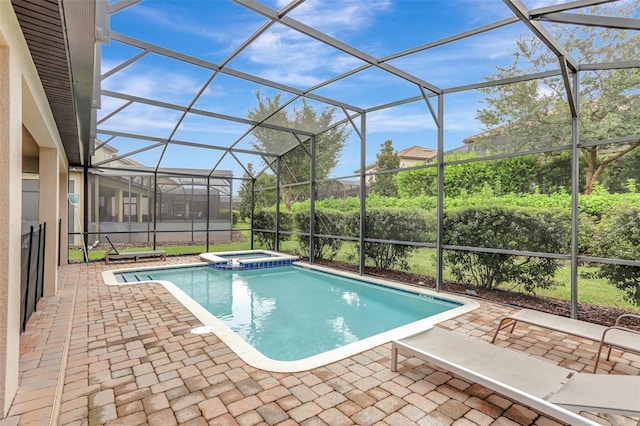 view of pool featuring glass enclosure and a patio