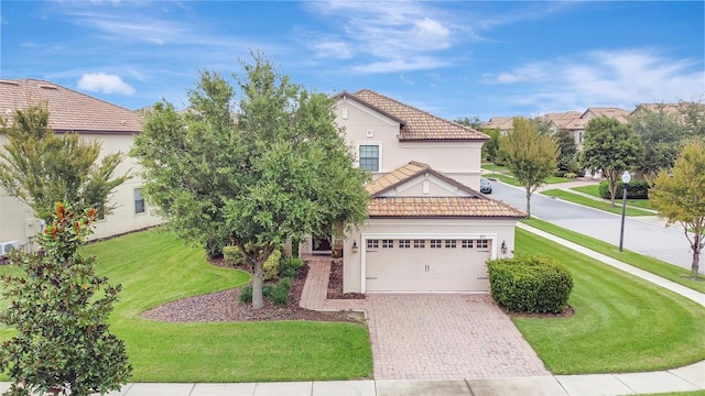 view of front of home featuring a front yard and a garage