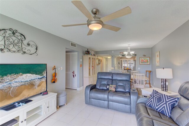 living room featuring ceiling fan with notable chandelier