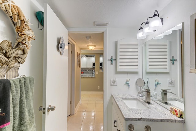 bathroom featuring vanity, a textured ceiling, and tile patterned floors