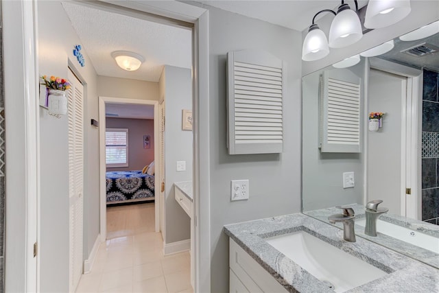 bathroom featuring vanity, a textured ceiling, and tile patterned floors