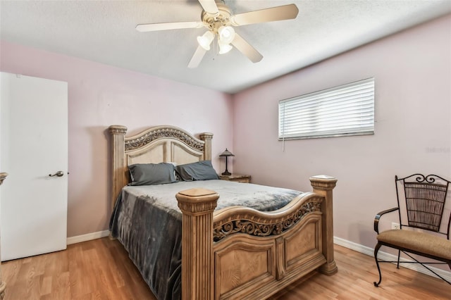 bedroom featuring ceiling fan and light hardwood / wood-style flooring