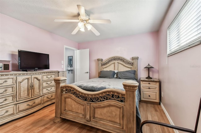 bedroom featuring light wood-type flooring and ceiling fan