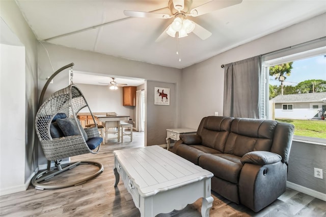 living room featuring ceiling fan and light wood-type flooring