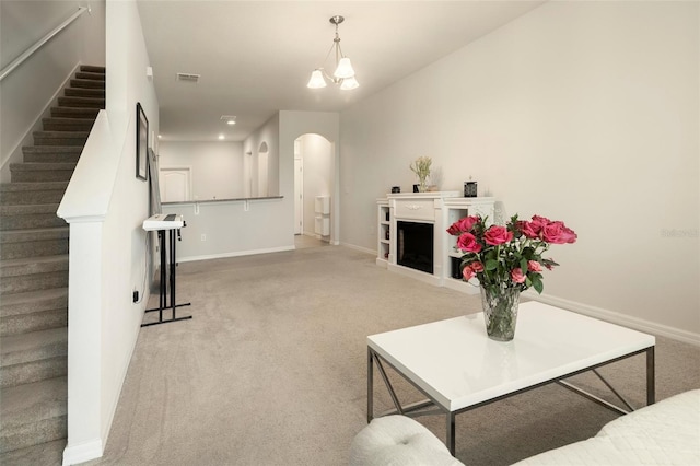 living room with an inviting chandelier and carpet