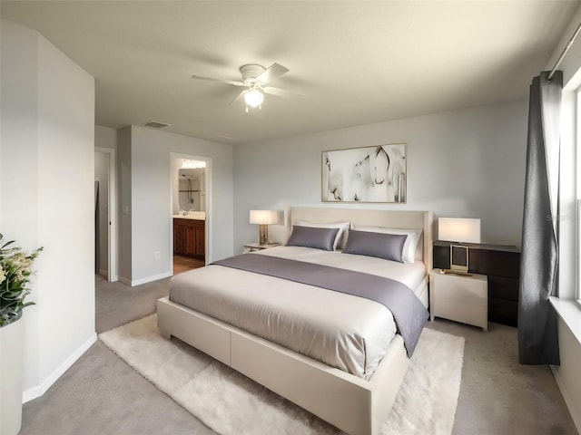 carpeted bedroom featuring connected bathroom and ceiling fan