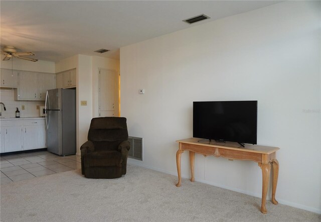 4338 Tahitian Gardens Cir Unit C, Holiday, FL 34691 - living area with ceiling fan, light colored carpet, and baseboards