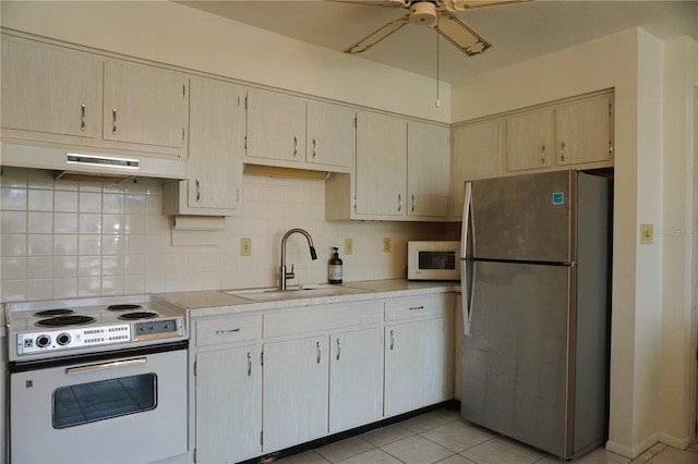 kitchen with ceiling fan, white appliances, sink, backsplash, and light tile patterned floors