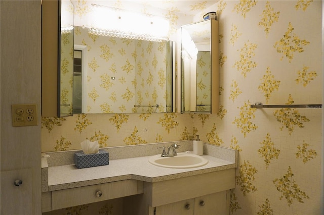 4338 Tahitian Gardens Cir Unit C, Holiday, FL 34691 - bathroom with vanity and wallpapered walls