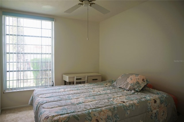 bedroom featuring light carpet and ceiling fan