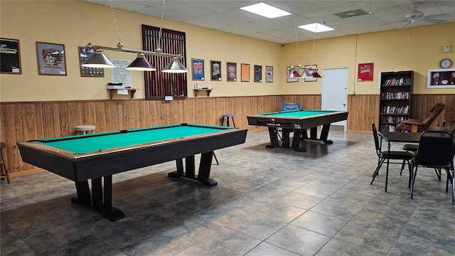 game room featuring wood walls, a drop ceiling, and pool table