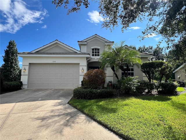 view of front of home with a garage and a front lawn