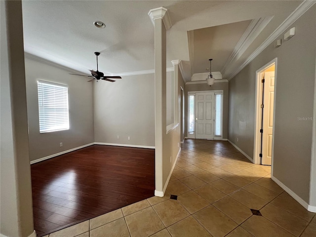 entryway featuring decorative columns, crown molding, light hardwood / wood-style flooring, and ceiling fan