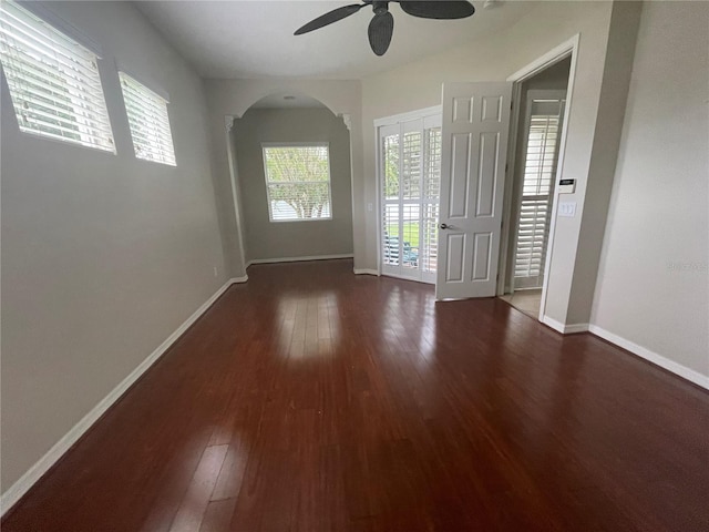 interior space with dark hardwood / wood-style flooring and ceiling fan