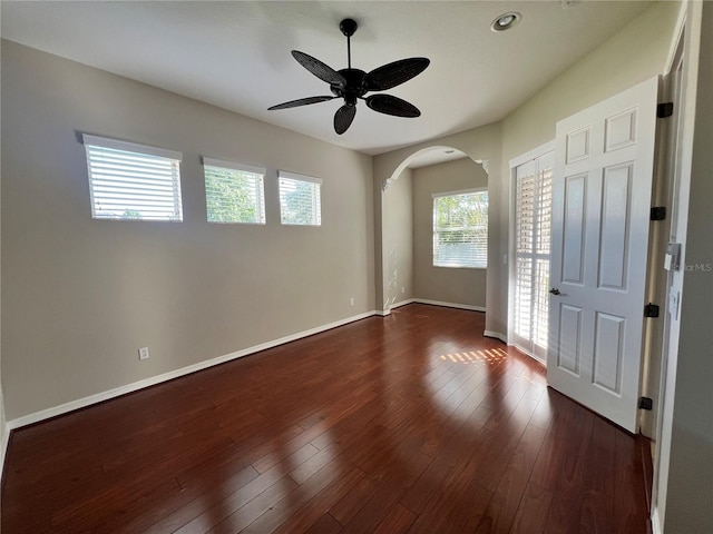 unfurnished room featuring dark hardwood / wood-style floors and ceiling fan