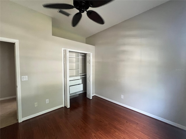 unfurnished bedroom featuring ceiling fan, a closet, and dark hardwood / wood-style floors