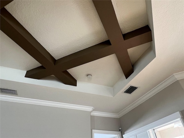 details featuring coffered ceiling, beamed ceiling, crown molding, and a textured ceiling