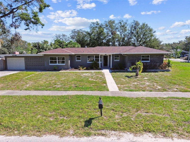 ranch-style house with a garage and a front lawn