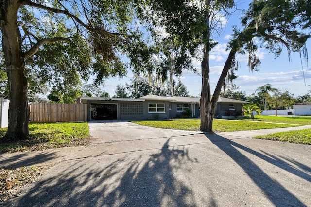 ranch-style house with a front yard and a carport