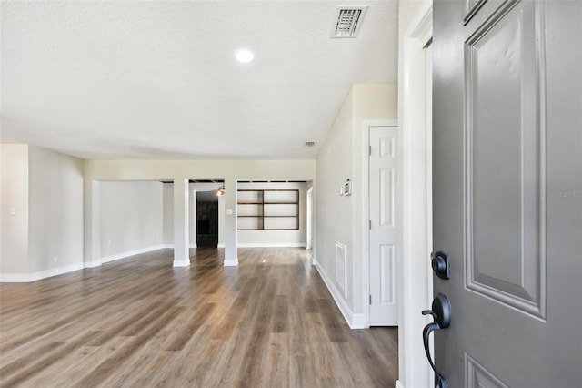 foyer featuring wood-type flooring and a textured ceiling