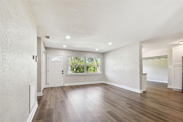 entrance foyer featuring dark hardwood / wood-style floors