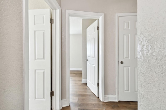 hall with dark hardwood / wood-style flooring