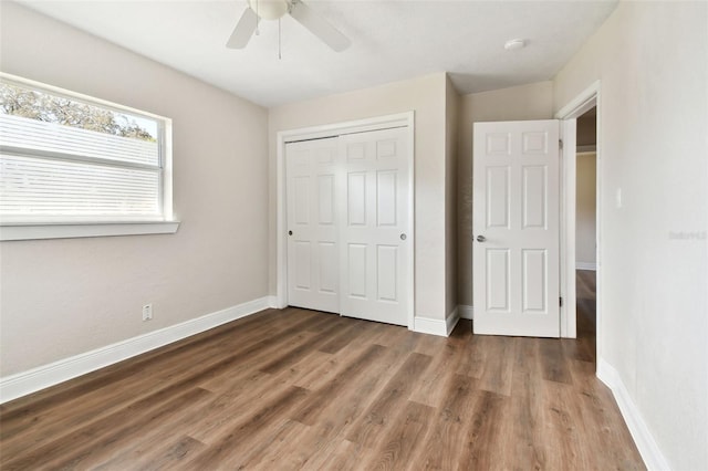 unfurnished bedroom featuring a closet, ceiling fan, and dark hardwood / wood-style floors