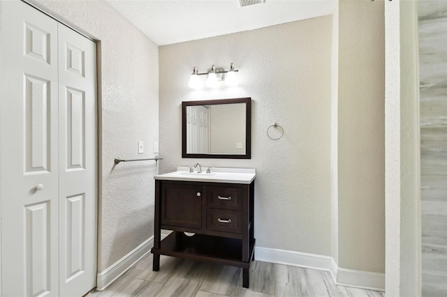 bathroom featuring vanity and wood-type flooring