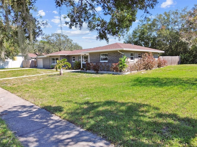 ranch-style home with a garage and a front lawn