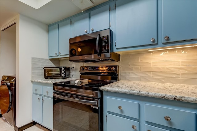 kitchen with blue cabinetry, backsplash, black range with electric stovetop, washer / clothes dryer, and light tile patterned floors