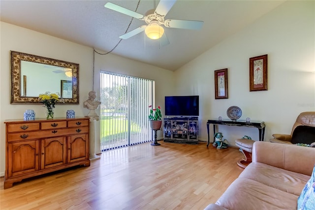 living room featuring lofted ceiling, light wood-type flooring, and ceiling fan