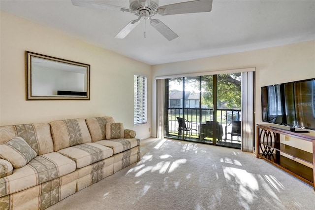 living room featuring carpet floors and ceiling fan