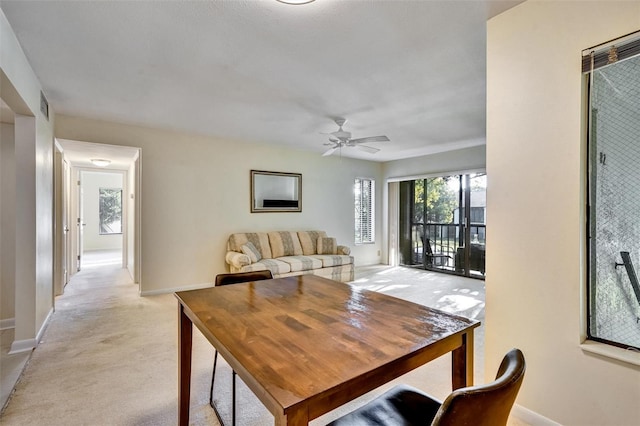 carpeted dining space featuring ceiling fan