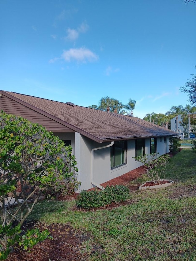 view of side of home featuring a yard