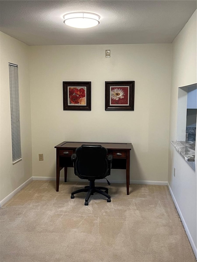 carpeted home office with a textured ceiling