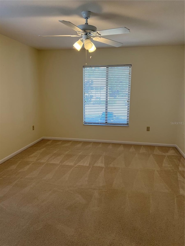 carpeted empty room featuring ceiling fan