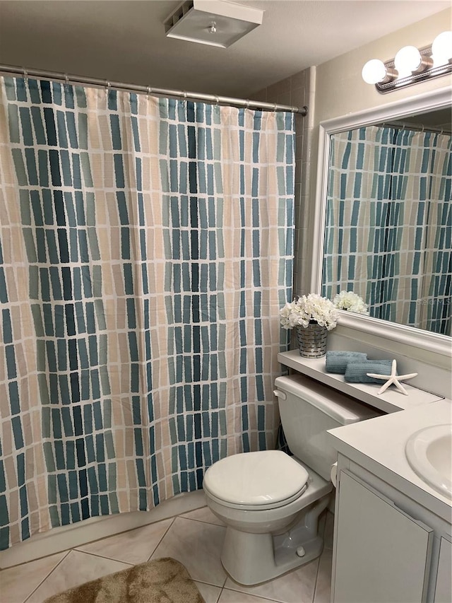 bathroom featuring tile patterned floors, vanity, and toilet