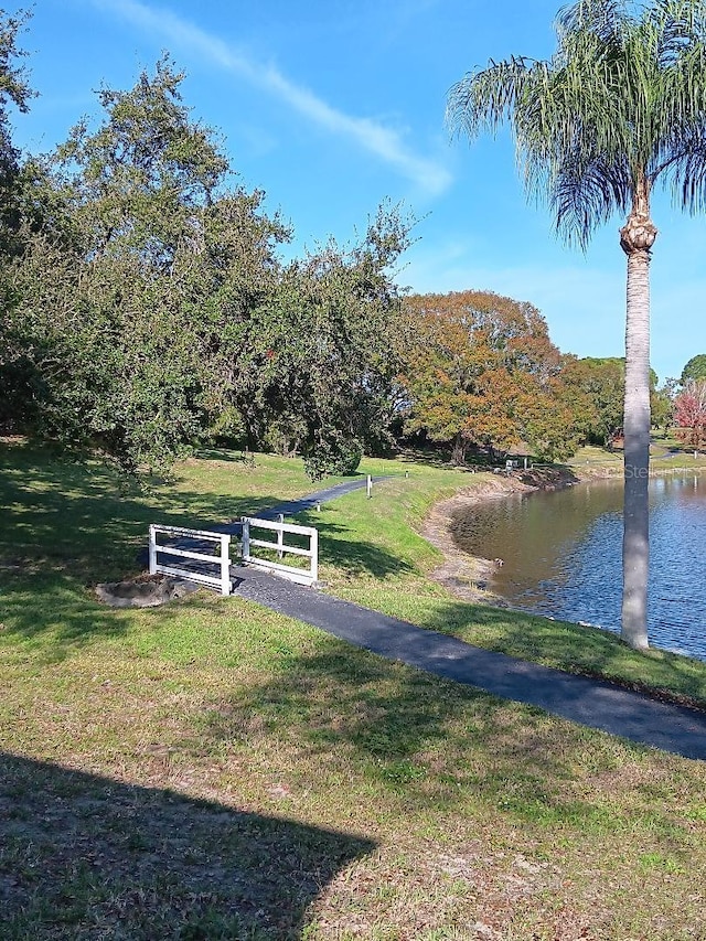 view of community featuring a yard and a water view