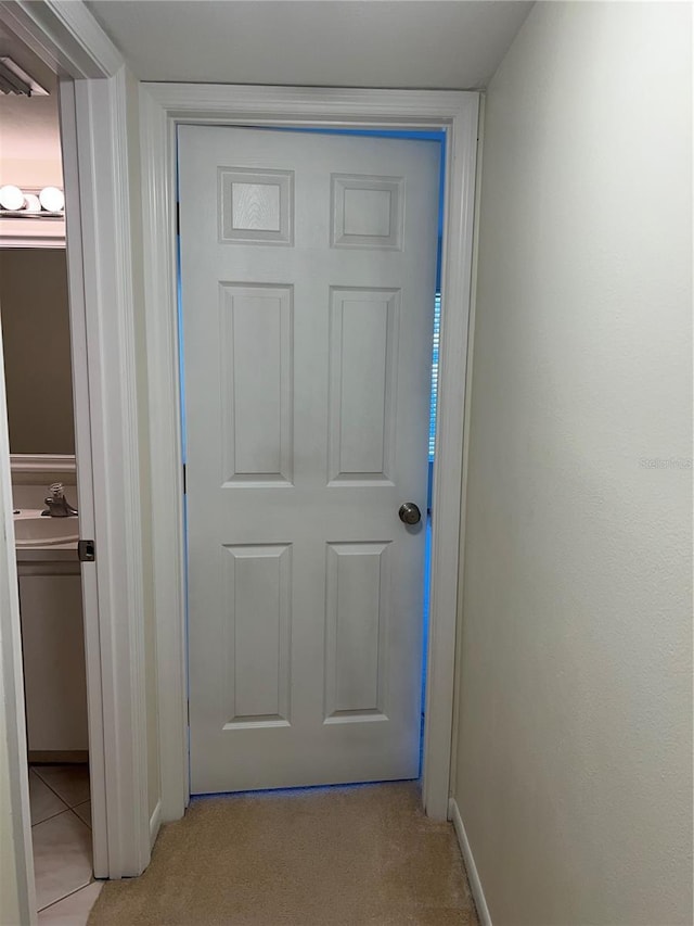 doorway to outside featuring light colored carpet