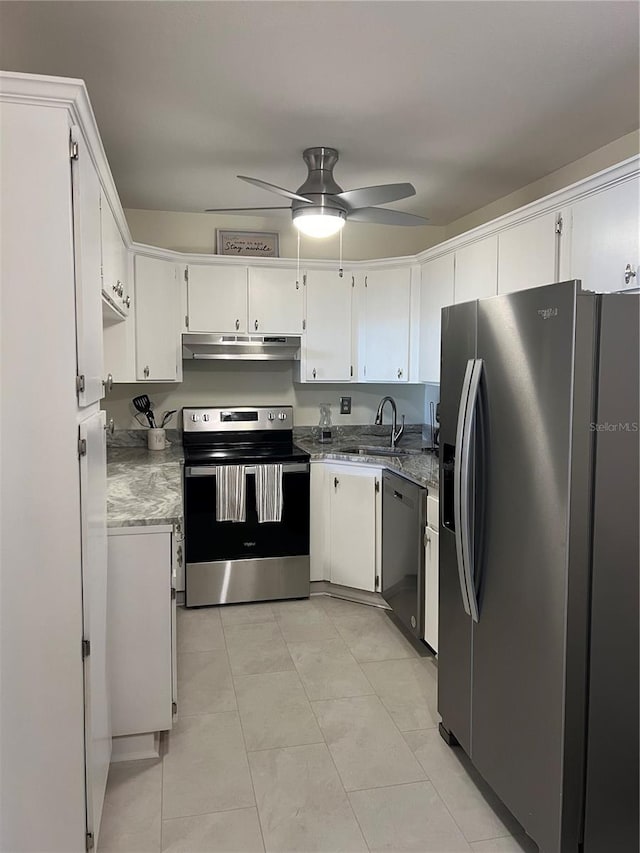 kitchen featuring appliances with stainless steel finishes, ceiling fan, sink, light tile patterned floors, and white cabinets