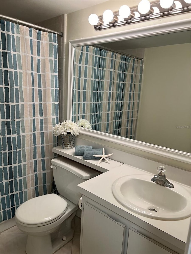 bathroom featuring tile patterned floors, curtained shower, vanity, and toilet