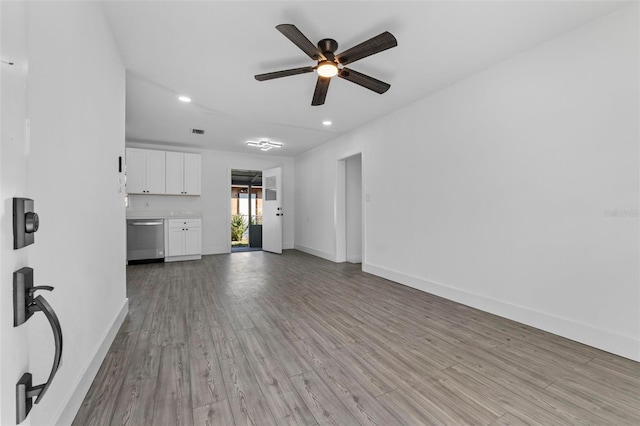 unfurnished living room with ceiling fan and light hardwood / wood-style floors