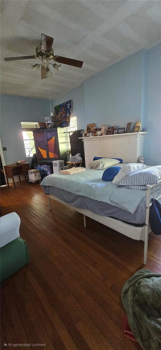 bedroom with dark hardwood / wood-style flooring, a textured ceiling, and ceiling fan